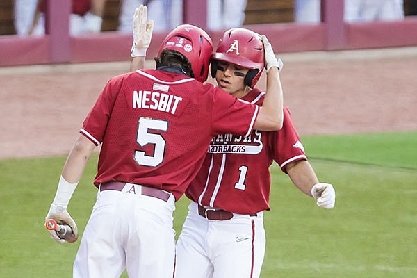 Arkansas' Robert Moore (right) is greeted by Jacob Nesbit after Moore hit a home run during the second inning of a game against South Carolina on Thursday, April 22, 2021, in Columbia, S.C. (Photo courtesy Jeff Blake, South Carolina Athletics via SEC pool)