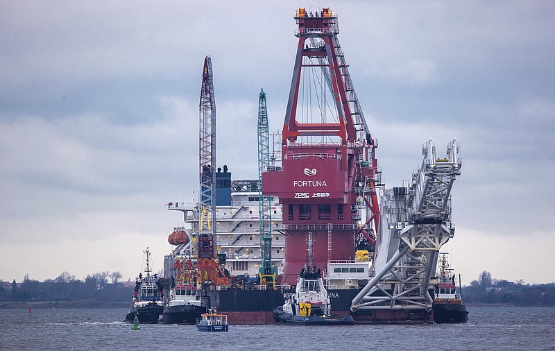 In this Jan. 14, 2021, file photo, tugboats get into position on the Russian pipe-laying vessel "Fortuna" in the port of Wismar, Germany. The special vessel is being used for construction work on the German-Russian Nord Stream 2 gas pipeline in the Baltic Sea. Pressure is growing on President Joe Biden to take action to prevent the completion of a Russian gas pipeline to Europe that many fear will give the Kremlin significant leverage over U.S. partners and allies. (Jens Buettner/dpa via AP)
