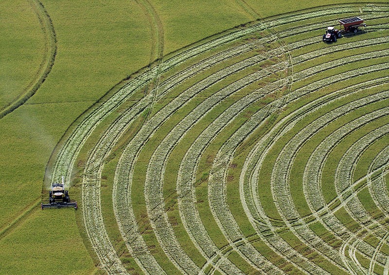 A farmer harvests a rice field near Stuttgart.
(Arkansas Democrat-Gazette file photo)
