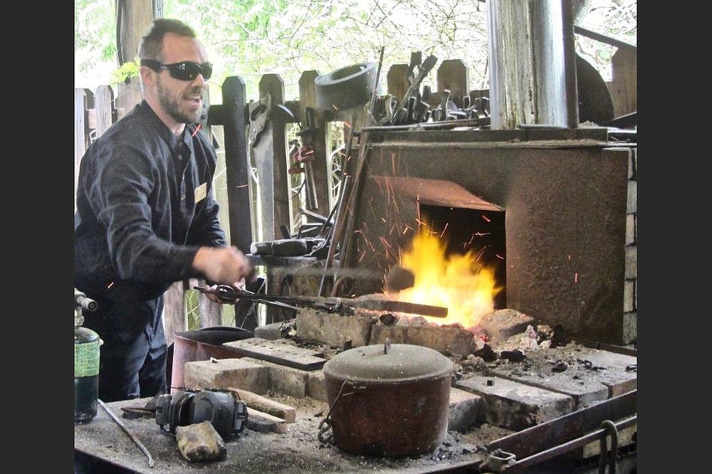 Blacksmith Sam Hibbs works with heated metal at Ozark Folk Center. (Special to the Democrat-Gazette/Marcia Schnedler)