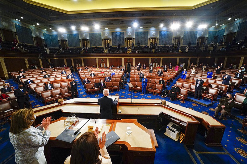 President Joe Biden addresses a joint session of Congress on Wednesday, April 28, 2021, in the House Chamber at the U.S. Capitol in Washington as Vice President Kamala Harris and House Speaker Nancy Pelosi, D-California stand and applaud. (Melina Mara/The Washington Post via AP, Pool)