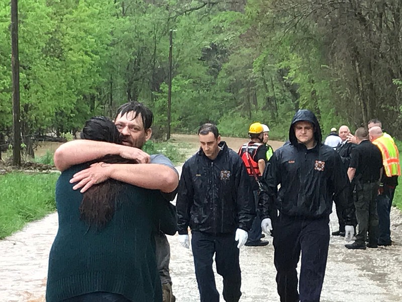 A man and a woman are reunited after the man was rescued from the water and the woman was rescued from a flooded home Wednesday near Little Flock. The Bella Vista and Rogers Water Rescue assisted Little Flock with the call.