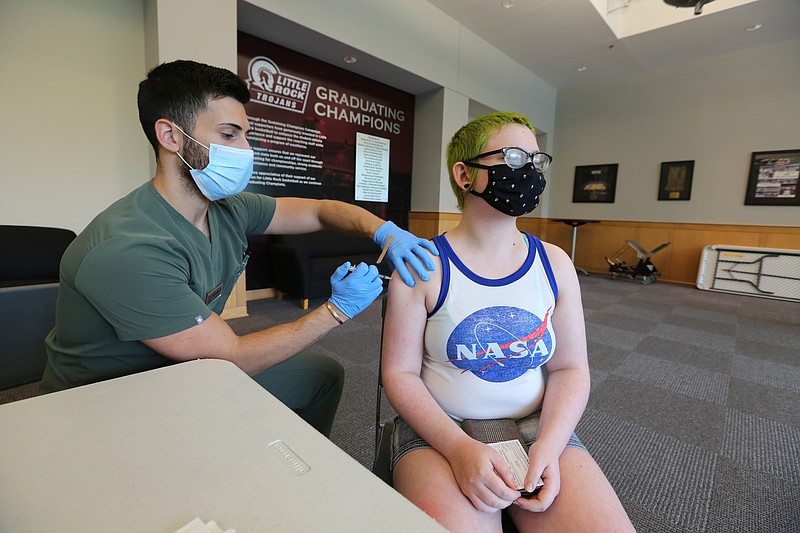 University of Arkansas at Little Rock junior Hailey Hudson of North Little Rock gets her first dose of the Pfizer vaccine from nurse Nick Kitchens during UALR's vaccine clinic put on by Don's Pharmacy on Wednesday, April 28, 2021, at the Jack Stephens Center in Little Rock. (Arkansas Democrat-Gazette/Thomas Metthe)
