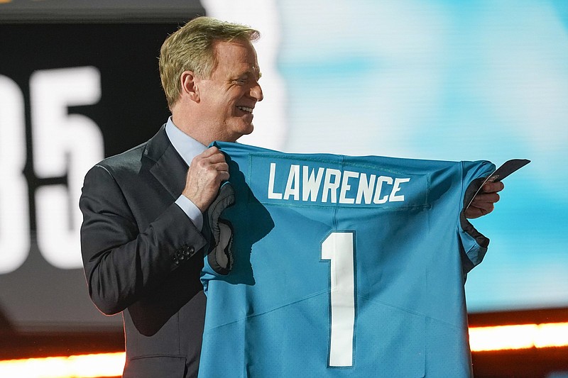 NFL Commissioner Roger Goodell holds a Jacksonville Jaguars jersey after announcing Clemson quarterback Trevor Lawrence as the No. 1 selection of the NFL Draft on Thursday night in Cleveland. Lawrence did not attend. More photos available at arkansasonline.com/430draft.
(AP/Tony Dejak)