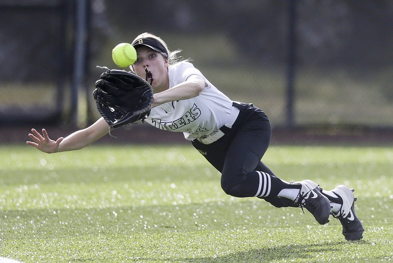 Bentonville left fielder Alleyna Rushing leaps to make an out during Thursday’s 9-0 victory over Rogers in a 6A-West clash at Bentonville High School. More photos at arkansasonline.com/430rhsbhs/.
(NWA Democrat-Gazette/Charlie Kaijo)