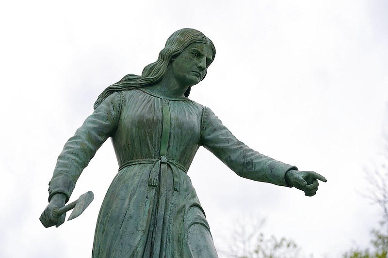 A statue of Hannah Duston, dated 1879, stands in the Grand Army of the Republic Park in Haverhill, Mass., on Wednesday, April 28, 2021. Two statues, one in Massachusetts and one in New Hampshire, honor the English colonist who, legend has it, slaughtered her American Indian captors after her baby was killed. (AP/Steven Senne)