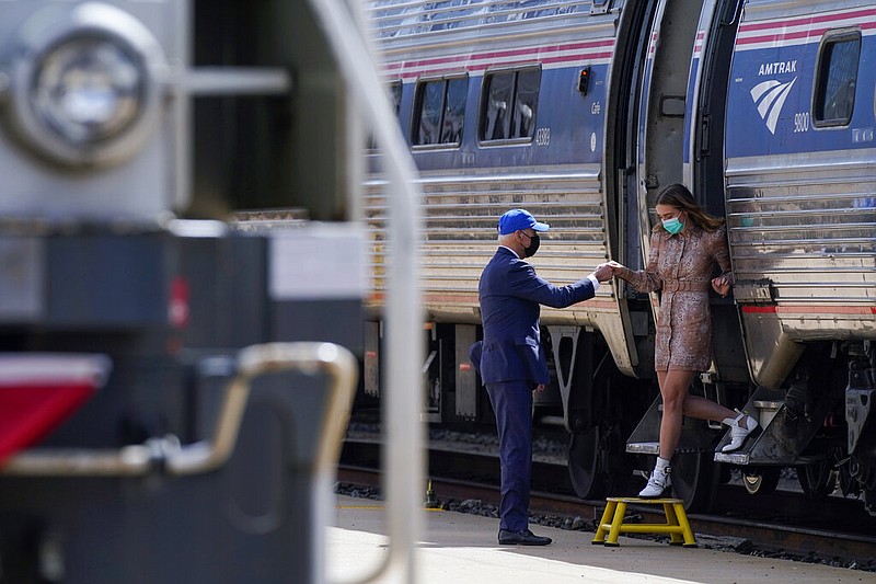 President Joe Biden offers his granddaughter, Finnegan Biden, a hand as she steps off a train car during an event to mark Amtrak's 50th anniversary at 30th Street Station in Philadelphia on Friday, April 30, 2021. (AP/Patrick Semansky)
