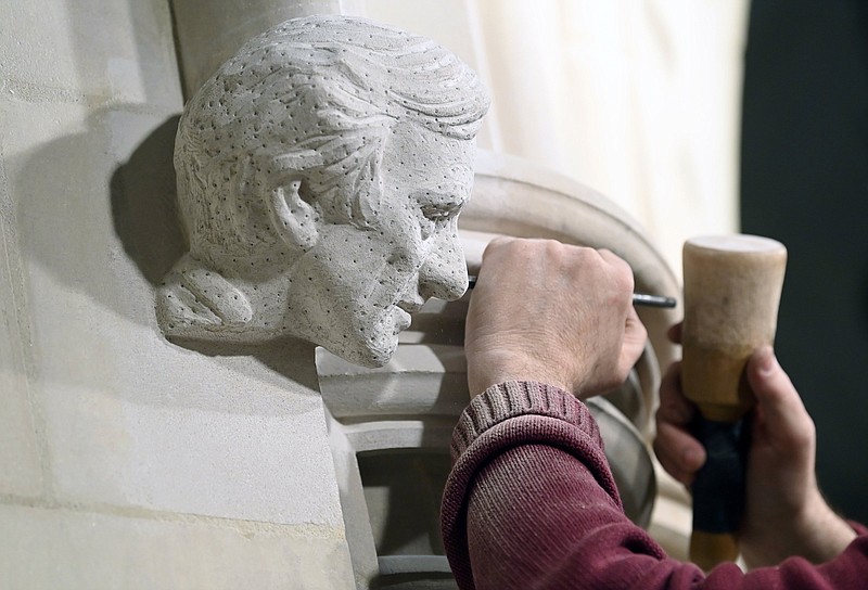 Washington National Cathedral stonemason Sean Callahan works on a sculpture of Holocaust survivor and Nobel Peace Prize-winning author Elie Wiesel on a scaffold in the Human Rights Porch at the cathedral in Washington in April. The carving completes a quartet of heads of prominent figures sprouting from the four corners of an alcove known as the Human Rights Porch, joining Mother Teresa, Rosa Parks and Jonathan Myrick Daniels, a young Episcopal theologian and civil rights crusader who was shot to death in Alabama in 1965, giving his life to protect a 17-year-old Black woman.
(AP/Carolyn Kaster)