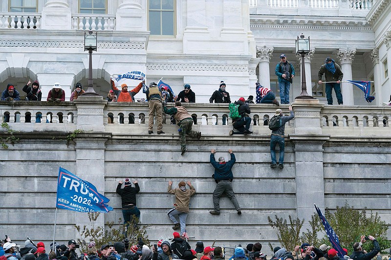 Supporters of then-President Donald Trump climb the west wall of the the U.S. Capitol on Jan. 6. Since the attack, Trump loyalists have worked to minimize the assault, while Democrats and others want justice for what they saw as a crime against democracy and the rule of law.
(AP/Jose Luis Magana)