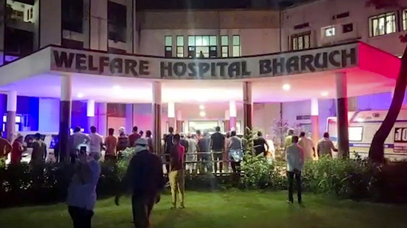 People gather Saturday outside the Welfare Hospital in Bharuch, western India after a deadly fire in the covid-19 ward of the hospital killed 18 patients. The cause is being investigated.
(AP/KK Productions)