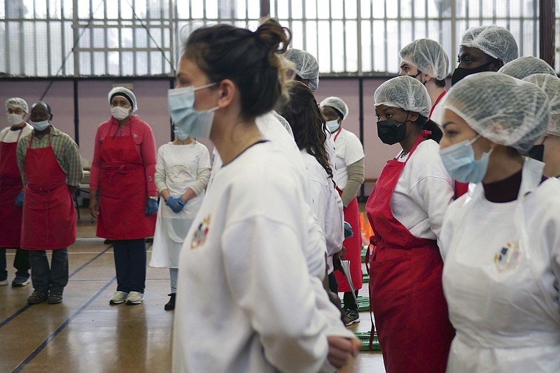 Members of Laissez Les Servir, or Let Them Serve, attend a briefing before meal preparation Thursday in Pierrefitte-sur-Seine, north of Paris.
(AP/Thibault Camus)