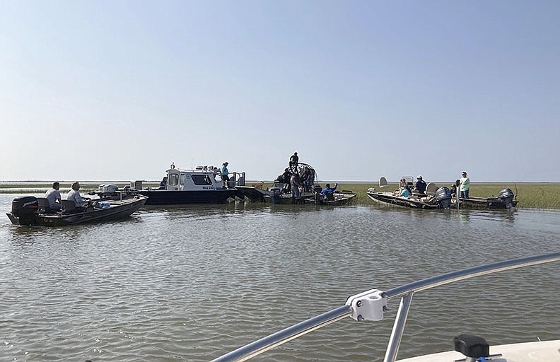 Volunteers gather Thursday on the Louisiana coast (left photo) before setting out to look for survivors of the Seacor Power. The United Cajun Navy, a non-profit that helps out during disasters, has been helping organize the search effort.
(AP/Rebecca Santana)