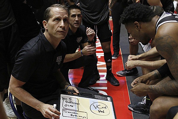 Nevada head coach Eric Musselman (foreground) and assistant coach Gus Argenal give instructions to players before the start of an NCAA college basketball game against New Mexico in Albuquerque, N.M., Saturday, Jan. 5, 2019. (AP Photo/Andres Leighton)