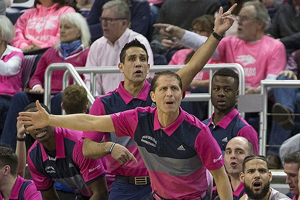 Nevada head coach Eric Musselman (front) and assistant coach Gus Argenal work the sidelines against Colorado State in the first half of an NCAA college basketball game in Reno, Nev., Wednesday, Jan. 23, 2019. (AP Photo/Tom R. Smedes)