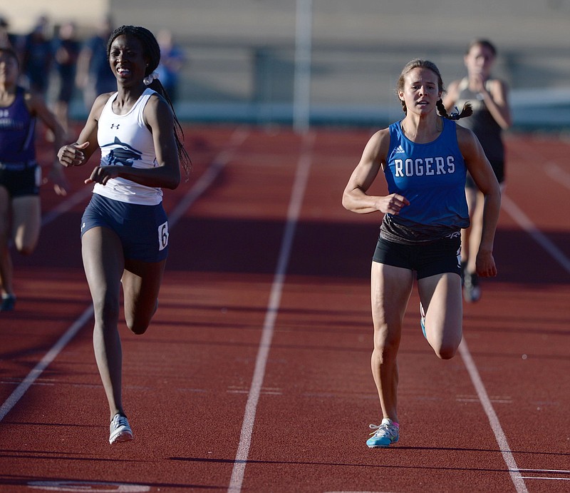 Kinleigh Hall (left) of Springdale Har-Ber pulls ahead of Grace Lueders of Rogers to win the 400 meters Friday during the 6A-West Conference Track and Field Meet in Bentonville.
(NWA Democrat-Gazette/Andy Shupe)