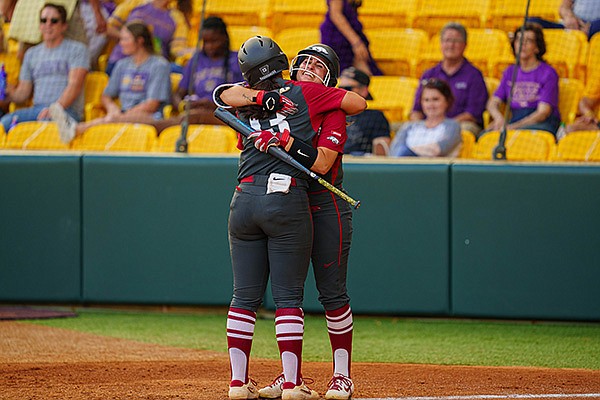 Arkansas' Kayla Green (13) is congratulated by Aly Manzo after Green hit a home run during a game against LSU on Monday, May 3, 2021, in Baton Rouge, La. (Photo by Rebecca Warren, LSU Athletics, via SEC pool) Arkansas' Kayla Green (13) is congratulated by Aly Manzo after Green hit a home run during a game against LSU on Monday, May 3, 2021, in Baton Rouge, La. (Photo by Rebecca Warren, LSU Athletics, via SEC pool)