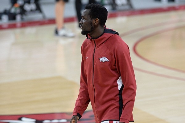 Arkansas forward Abayomi Iyiola warms up Tuesday, Feb. 16, 2021, before the start of the first half of play against Florida in Bud Walton Arena.