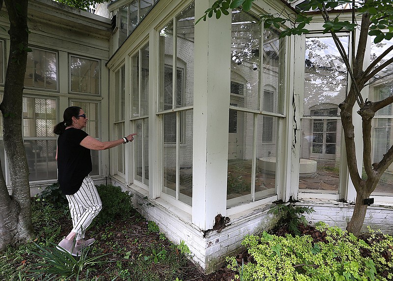 Capi Peck points to her grandmother’s name Tuesday on the list of the Women’s Emergency Committee at the Terry House in Little Rock. On Wednesday, Preserve Arkansas came out with its list of most endangered properties in Arkansas, and the Terry mansion is on the list.
(Arkansas Democrat-Gazette/Thomas Metthe)