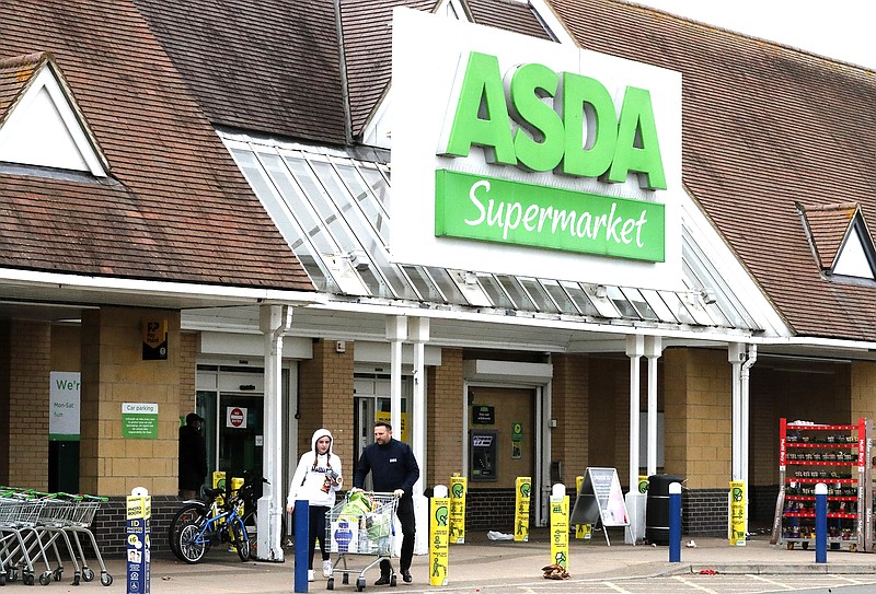 People leave an Asda supermarket in London in March. Walmart Inc.’s sale of Asda in the U.K. has received the approval of that nation’s competition authority.
(AP/Frank Augstein)