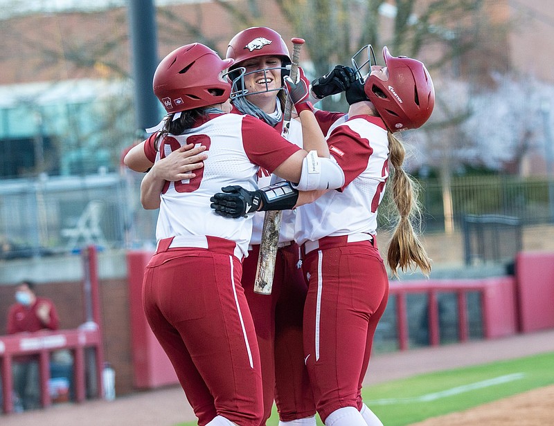 Arkansas Junior Linnie Malkin (22) (middle) celebrates with teammates after two run homer at the bottom of the fourth against Mississippi at Bogle Park, University of Arkansas , Fayetteville, Ark., on Friday,, March 25, 2021  / Special to NWA Democrat-Gazette/ David Beach.