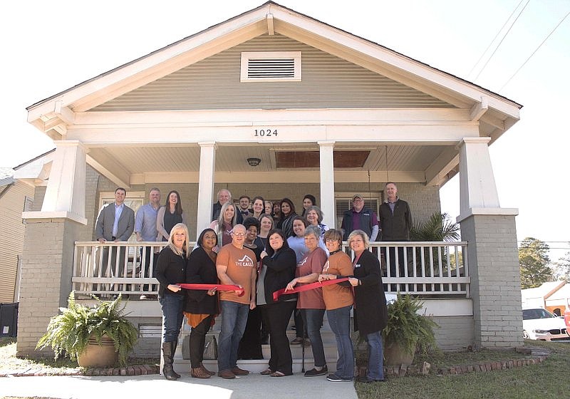 In this 2020 file photo, Karen Hicks, center at the front, cuts the ribbon at the grand opening of the CALL Support Center at Euclid and Fifth Streets in El Dorado. On Saturday, April 8, The CALL is teaming with Steadfast Supply and Company and several other local businesses to hold a fundraiser at this location. (File Photo)