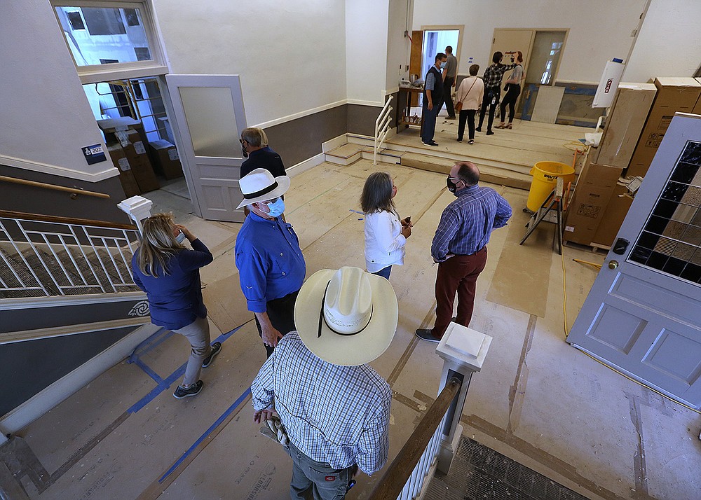 Visitors tour the Woodruff School after the announcement of Preserve Arkansas’ 2021 Most Endangered Places list during a news conference outside the building Wednesday in Little Rock. The Woodruff School was included in the 2017 Most Endangered Places list. It is being rehabilitated with federal and state historic tax credits, and will offer apartments and restaurant space.
(Arkansas Democrat-Gazette/Thomas Metthe)