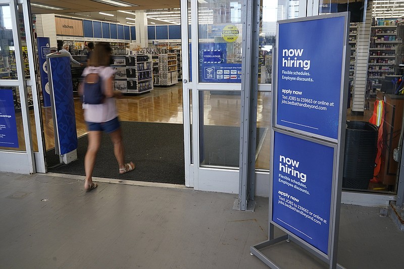 A “now-hiring” sign sits Tuesday at the entrance to a Bed, Bath and Beyond store in Miami. (AP/Marta Lavandier)