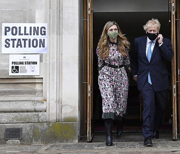 Prime Minister Boris Johnson and his fi ancee Carrie Symonds leave Methodist Central Hall in central London after voting Thursday in one of scores of elections, including somein Scotland that could have sizable repercussions for the United Kingdom. More photos at arkansasonline.com/57ukpolls/.
(AP/PA/Stefan Rousseau)