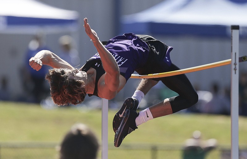 Fayetteville’s Sam Hurley cleared 6 feet, 5 inches to win the boys high jump Thursday at the Class 6A state track and field meet at Rogers Heritage. He also won the long jump and the pole vault, and finished second in the 110-meter hurdles. More photos available at arkansasonline.com/57track6a.
(NWA Democrat-Gazette/Charlie Kaijo)