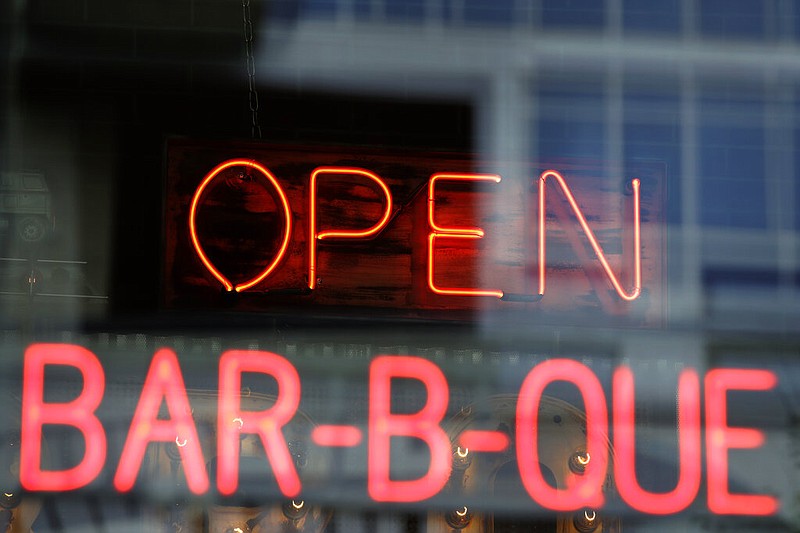 A restaurant displays an open sign as it opens for dine-in customers in downtown Kansas City, Mo., in this May 15, 2020, file photo. (AP/Charlie Riedel)