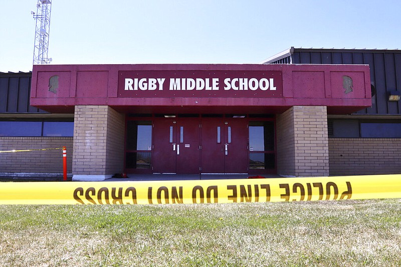 Police tape marks a line outside Rigby (Idaho) Middle School after a shooting there earlier Thursday. Authorities said that two students and a custodian were injured, and a male student was taken into custody. (AP/Natalie Behring)