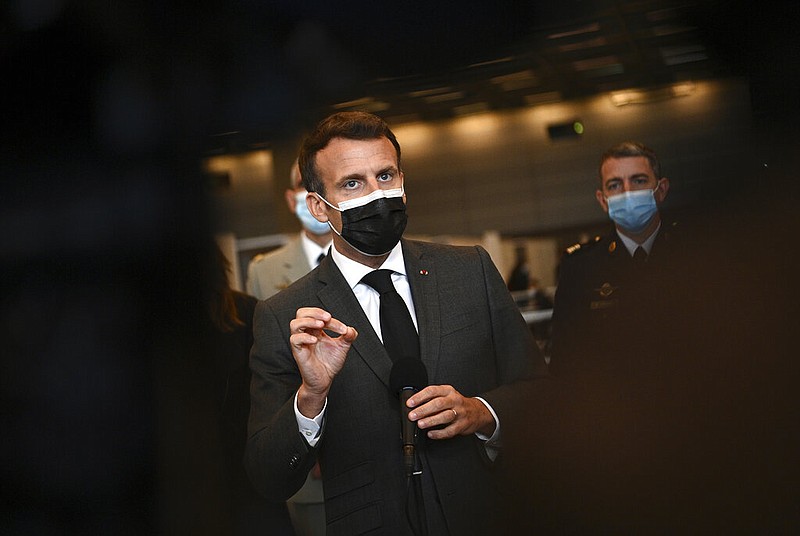 French President Emmanuel Macron talks to the press as he visits a giant vaccination center against covid-19 during its inauguration at Porte de Versailles convention centre in Paris, Thursday, May 6, 2021. (Christophe Archambault, Pool Photo via AP)