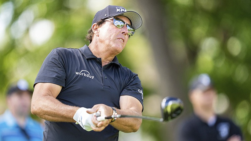 Phil Mickelson watches his tee shot on the fifth hole during the first round of the Wells Fargo Championship golf tournament at Quail Hollow on Thursday, May 6, 2021, in Charlotte, N.C. (AP Photo/Jacob Kupferman)