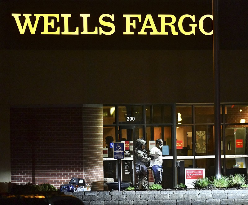 Police lead Ray R. McNeary away from the Wells Fargo branch Thursday after a standoff of more than eight hours in St. Cloud, Minn.
(AP/St. Cloud Times/Dave Schwarz)