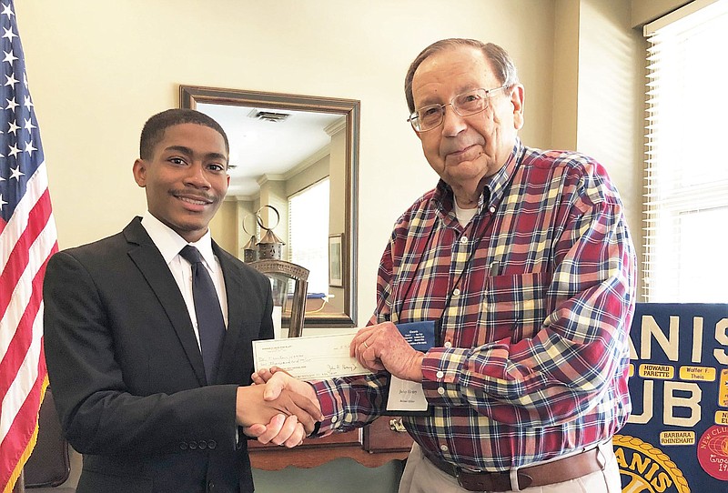 Trenton Harris (left) accepts the Kiwanis Club scholarship from John Henry, Kiwanis Club president. 
(Special to The Commercial)