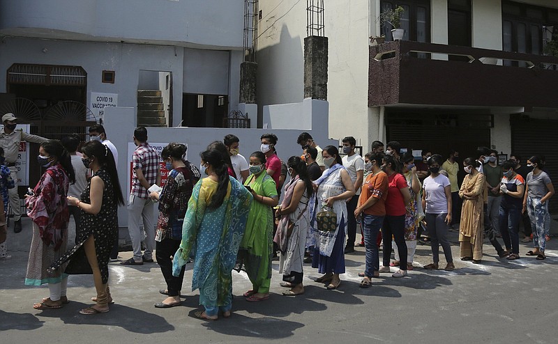 People line up to receive their first doses of covid-19 vaccine at a facility Friday in Jammu, India. More photos at arkansasonline.com/58india/.
(AP/Channi Anand)