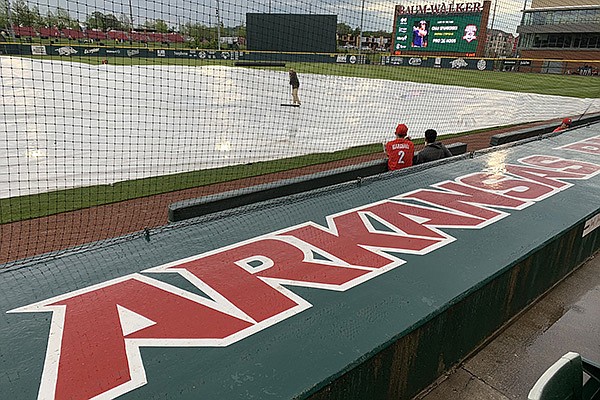 A tarp sits on the field prior to a game between Arkansas and Georgia on Friday, May 7, 2021, at Baum-Walker Stadium in Fayetteville.
