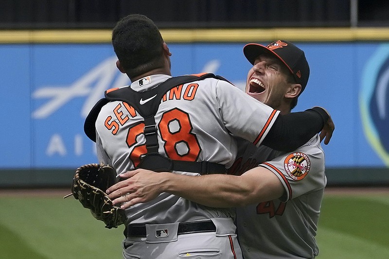 Baltimore Orioles starting pitcher John Means, right, hugs catcher Pedro Severino after Means threw a no-hitter in the team’s baseball game against the Seattle Mariners on Wednesday. The Orioles won 6-0 and will open a four-game series at home today against Boston. (AP Photo/Ted S. Warren)