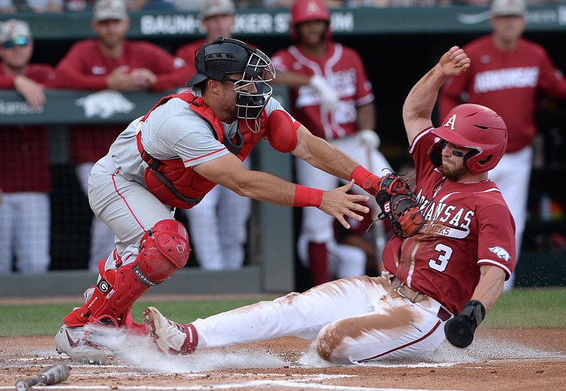 Arkansas left fielder Zack Gregory (3) is tagged out Saturday, May 8, 2021, by Georgia catcher Corey Collins while attempting to score on a fly ball out to center field during the first inning of play against Georgia at Baum-Walker Stadium in Fayetteville. Visit nwaonline.com/210509Daily/ for today's photo gallery. .(NWA Democrat-Gazette/Andy Shupe)