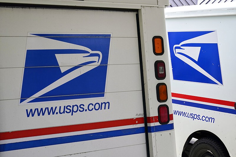 Mail delivery vehicles are parked outside a post office in Boys Town, Neb., in this Aug. 18, 2020, file photo. The United States Postal Service announced in February 2021 that it has chosen Oshkosh Defense to build its next-generation mail-delivery vehicle. (AP/Nati Harnik)
