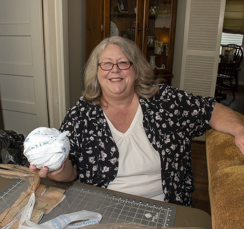 Pat Roby at her home on 04/27/2021 holds a ball of plarn (plastic yarn) she makes from plastic grocery bags then crochets into mats for the homeless. (Arkansas Democrat-Gazette/Cary Jenkins)