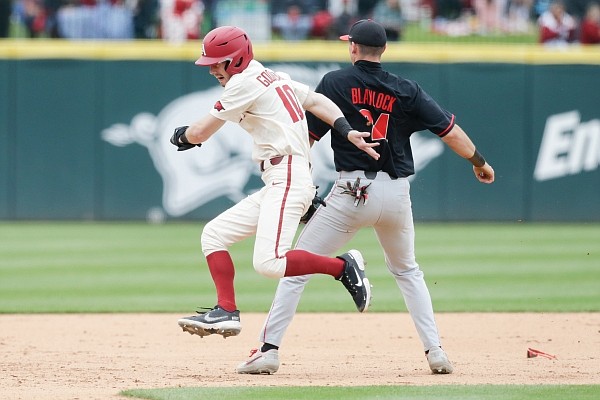 Arkansas infielder Matt Goodheart (10) runs to third colliding into a Georgia player, Sunday, May 9, 2021 during the fifth inning of a baseball game at Baum-Walker Stadium in Fayetteville. Check out nwaonline.com/210510Daily/ for the photo gallery.