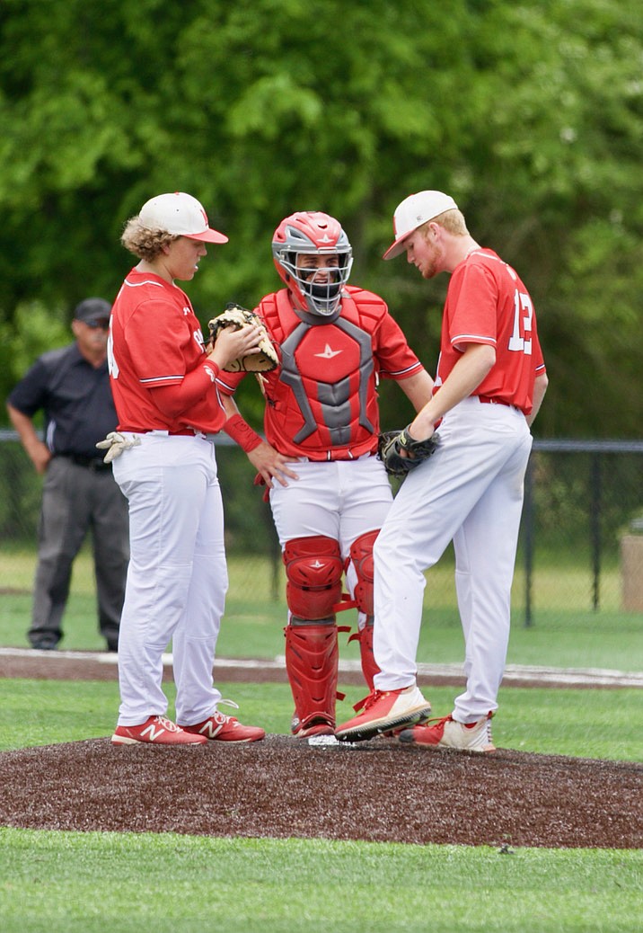 Magnolia’s Hunter Buford (from left), Dalen Blanchard and Tanner Nielsen hold a meeting on the mound during Friday’s South Region game. Nielsen went the distance. The Panthers open Class 4A State Tournament play at 10 a.m. Friday at Morrilton. (Photo by Bill Nielsen)