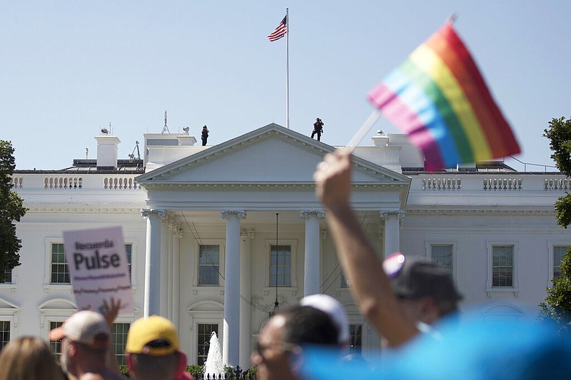 FILE - In this Sunday, June 11, 2017 file photo, Equality March for Unity and Pride participants march past the White House in Washington. (AP/Carolyn Kaster)