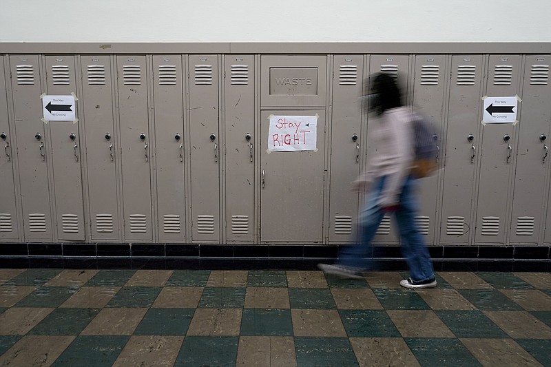 A student walks between classes at Wyandotte High School in Kansas City, Kan., on the first day of in-person learning Wednesday, March 30, 2021. The school, like other schools nationwide, has made extra efforts to keep kids at risk of dropping out engaged as classes went virtual due to the pandemic. (AP Photo/Charlie Riedel