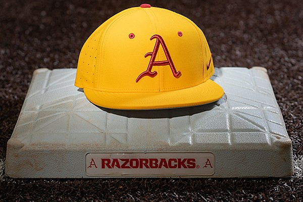 This image provided by University of Arkansas Athletics shows a specialty baseball hat the Razorbacks will wear to promote childhood cancer awareness.