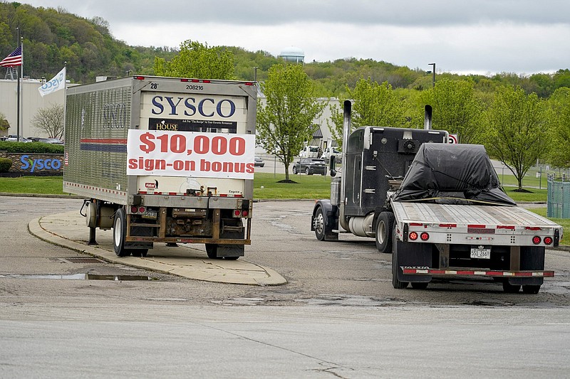 A tractor-trailer rig pulls into a terminal for a trucking company that is offering $10,000 hiring bonuses to drivers earlier this month in Harmony, Pa. New claims filed for unemployment benefits fell last week.
(AP/Keith Srakocic)