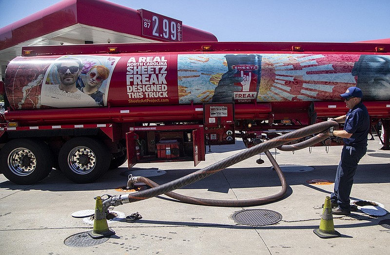 A tanker driver delivers 9,000 gallons of fuel Thursday at a Sheetz convenience story in Raleigh, N.C. Georgia-based Colonial Pipeline said gasoline deliveries were underway in all of its markets, but it will be “several days” before supplies return to normal.
(AP/The News & Observer/Travis Long)