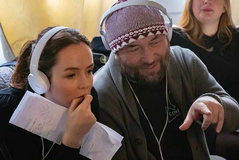 Irish actor Valene Kane, who plays a British journalist in “Profile,” a movie presented in text messages, Skype calls and laptop screenshots, watches a scene play back with director Timur Bekmambetov on the movie’s set.