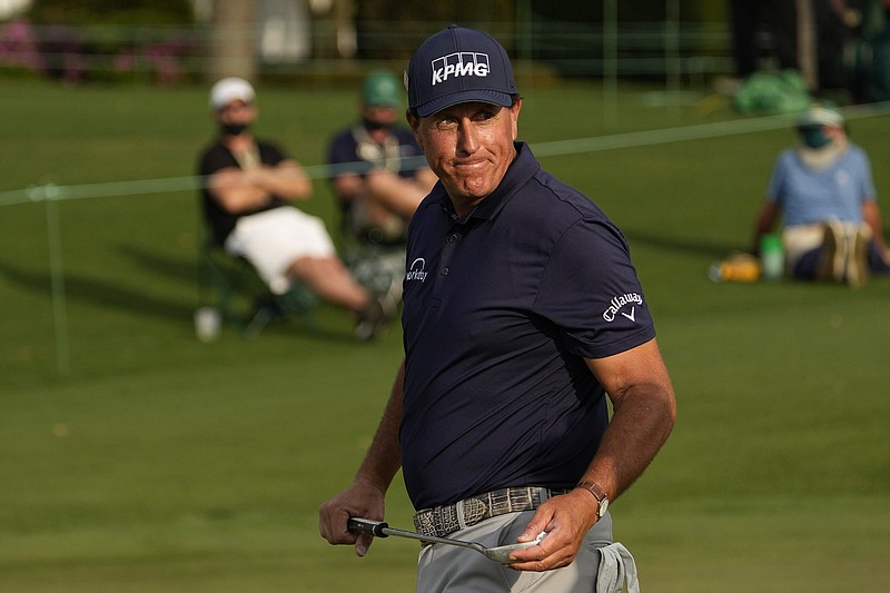 Phil Mickelson walks off the 18th green during the first round of the Masters golf tournament on Thursday, April 8, 2021, in Augusta, Ga. (AP Photo/Matt Slocum)